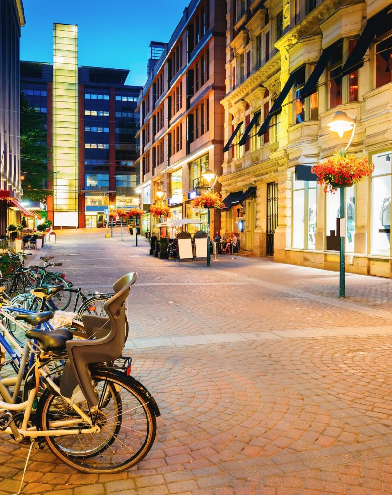 Helsinki, Finland. Bicycles Parked Near Storefronts In Kluuvikat